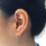 Model wearing Short U-shape wire Earrings with single post in - rose gold