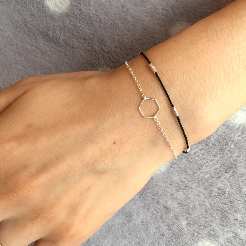 Wrist wearing blue silk bracelet with silver wire